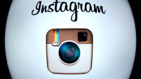The Instagram logo is displayed on a tablet in Paris.