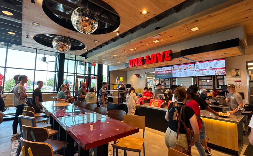 Diners lined up to order at the new Raising Cane’s chicken restaurant when it opened on Tuesday morning.