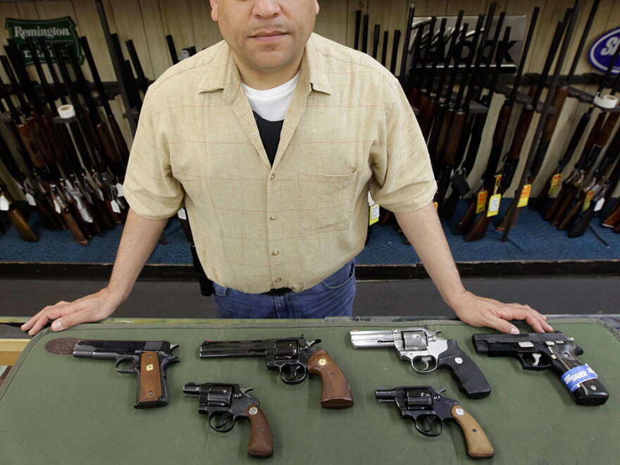 Mark Diaz, manager of Schrank's Smoke 'n Gun shop, displayed several handguns for sale at the store last year in Waukegan, Ill., north of Chicago. When the Supreme Court ruled Monday that most Americans can have a handgun in their homes for self-defense, it left Chicago officials scrambling to put together a new handgun law.
