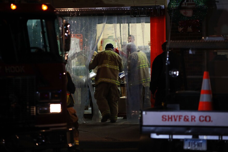 FILE: A firefighter from the Sandy Hook Fire and Rescue walks into the firehouse near the Sandy Hook School on December 14, 2012 in Newtown, Connecticut.