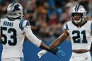 Carolina Panthers Players Brian Burns (53) and Jeremy Chinn (21) dap each other up after a successful defensive play.