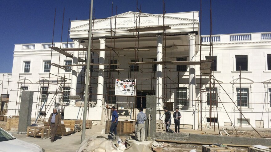 Construction workers in Irbil, in the Kurdish north of Iraq, work on Kurdish business tycoon Shihab Shihab's version of the White House.