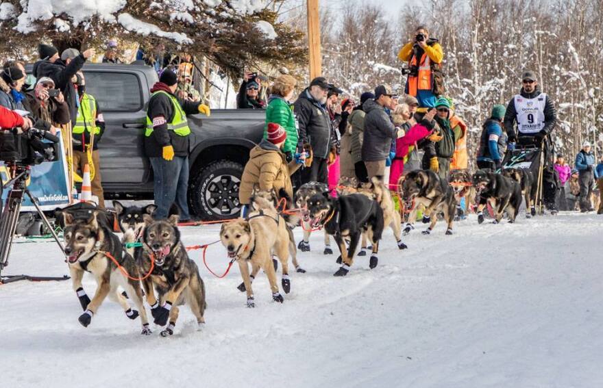 Peter Kaiser and his team of dogs take off at the start of the Iditarod race.