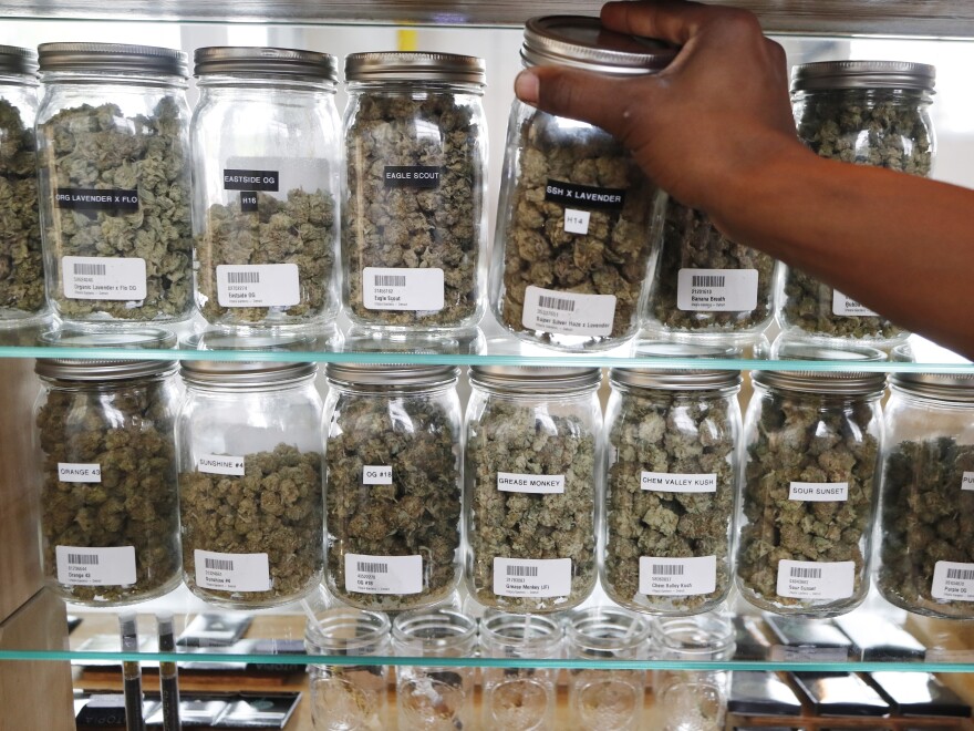 Michigan has become the first state in the Midwest to legalize recreational marijuana, after voters approved a ballot measure Tuesday. Here, a clerk reaches for a container of marijuana buds at Utopia Gardens, a medical marijuana dispensary in Detroit.