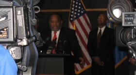 Councilor Jack Henderson talks with reporters