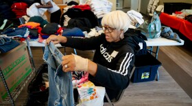 Doris Patrick, an UnGUN Institute volunteer from Cool Valley, sorts through dozens of boxes of clothes to be donated to the community on Tuesday, Nov. 4, 2025, at the organization’s office on Tuesday, Nov. 4, 2025, in St. Louis’ Hamilton Heights neighborhood.