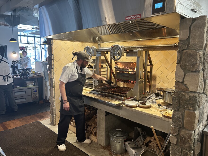 Matthew Kite sears steaks on the wood-fired grill