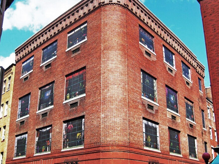 Swain covered boarded up windows of a 1909 electrical substation building in Boston with giant photos of furnished rooms.