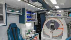 The interior of an ambulance is filled with a CT machine and other medical supplies.