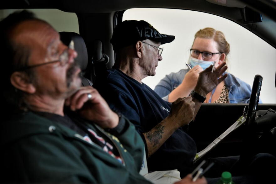 Workers get information about job openings at a drive-thru employment fair in Elkhart during the pandemic.