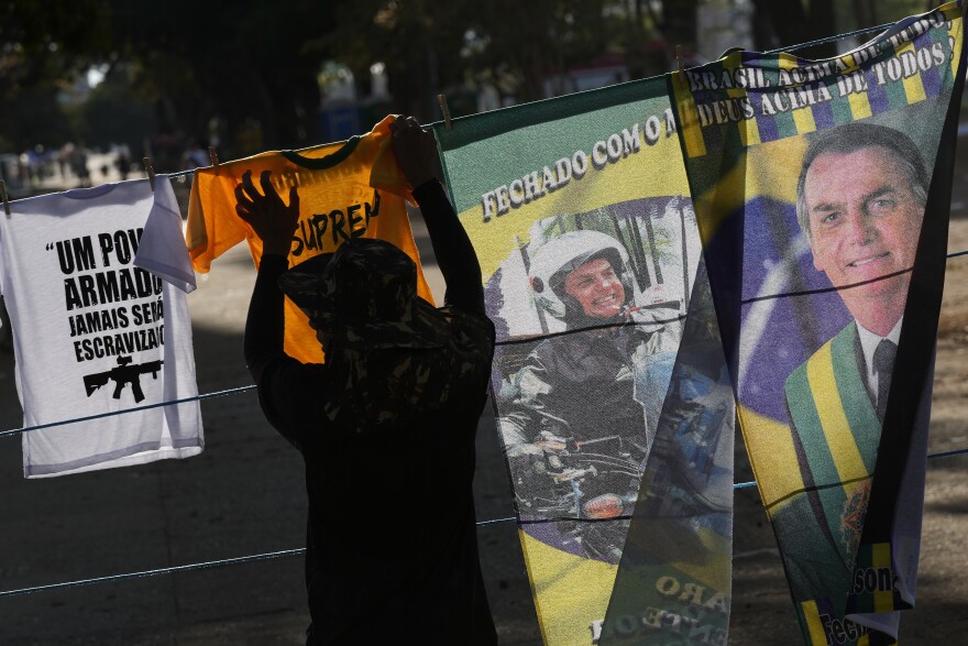 A vendor hangs electoral merchandise of Brazil's President Jair Bolsonaro, who is running for reelection next month.