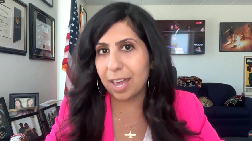 woman with pink jacket and dark hair