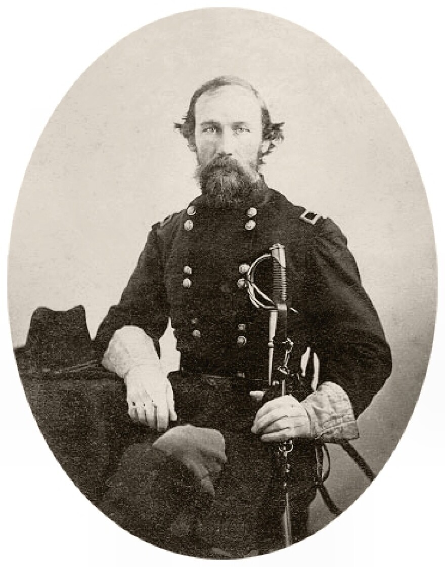  A portrait of E.J. Davis in his Union Army uniform. He is holding a sword in his right hand. 