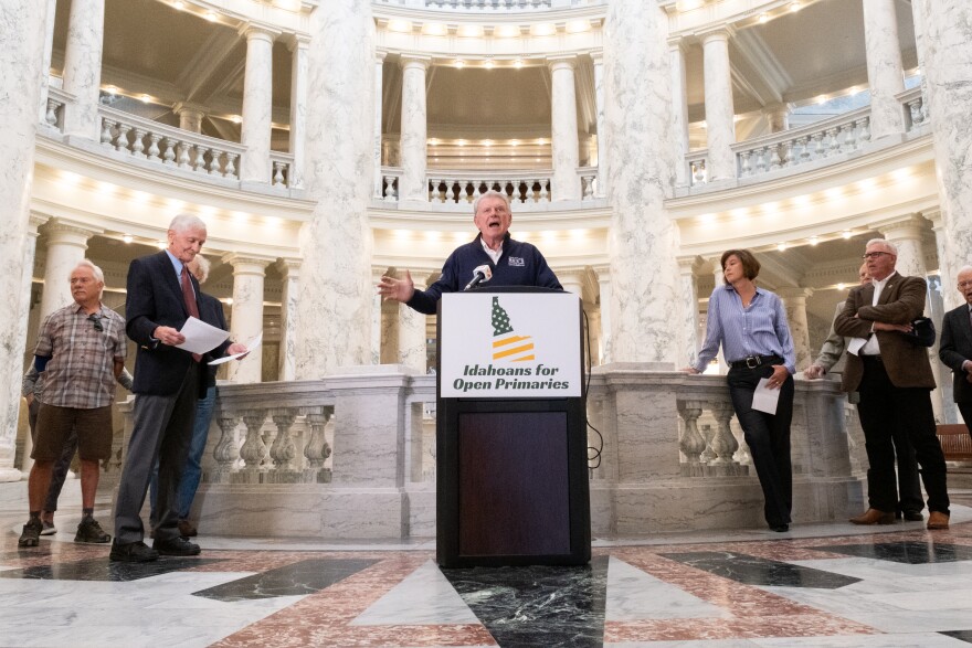 Former Idaho Republican Governor Butch Otter speaking to reporters.