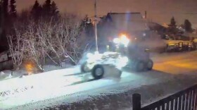 A grader clears the roads in downtown Homer.