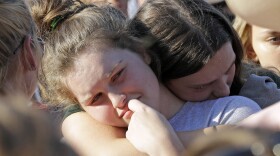 Santa Fe High School sophomore Averi Gary (center) is comforted during a vigil after the deadly mass shooting in Texas on Friday.