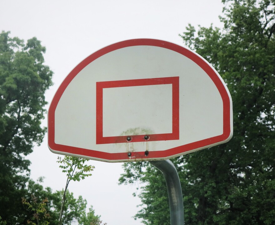 A basketball court at 70th Street and Roe in Prairie Village has no hoop, but you can see the rust marks where metal used to be.