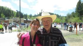 Angie Sewalson taking a picture with her grandfather, John Baumann, after finishing Finished a half marathon in Deadwood, SD.