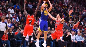 Golden State Warriors guard Klay Thompson shoots the ball against Chicago Bulls forward Justin Holiday (7) and guard Zach LaVine (8) during Monday night's game. Thompson broke the NBA's single-game record for 3-pointers.