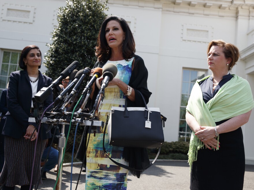 Marjorie Dannenfelser, president of the Susan B. Anthony List (right) and Seema Verma (left), administrator of the Centers for Medicare and Medicaid Services, look on as Concerned Women for America CEO Penny Nance speaks with reporters outside the White House on Thursday.