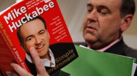 Former Arkansas Governor Mike Huckabee signs a copy of his new book at the National Press Club in Washington. The winner of the Iowa GOP caucus in 2008, Huckabee is said to be considering another run for the U.S. presidency in 2012.