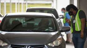 Drivers line up to cast ballots at NRG Stadium in Houston on the first day of early voting. Republican activists say the drive-thru polling site is unconstitutional. 
