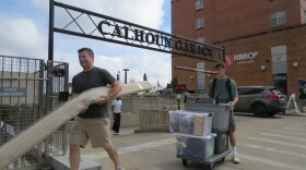 A new student and their parent push and carry items as they move into a dorm at Calhoun Hall at the University of Cincinnati. 