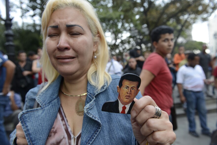 A supporter of Venezuelan President Hugo Chavez cries after learning of his death in Caracas on March 5, 2013.