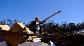 Corky Potts looks through all the rubble in Arabi, LA on Wednesday morning.