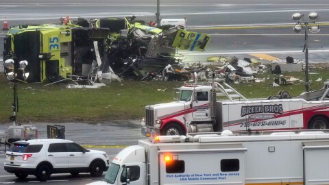 A Port Authority firetruck lays on its side just off the runway at LaGuardia Airport, Monday, March 23, 2026, after colliding with an Air Canada jet shortly after it landed late Sunday night in New York. (AP Photo/Seth Wenig)