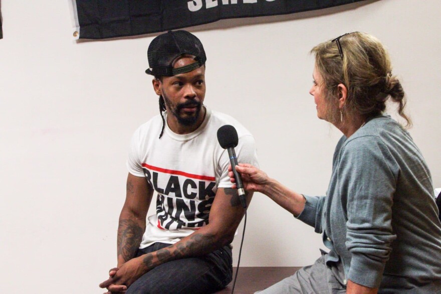 Maj Toure, founder of the activist group Black Guns Matter, speaks with Here & Now's Robin Young. (Dean Russell/Here & Now)