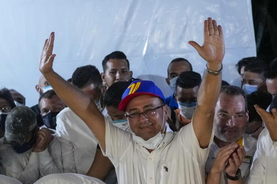 Opposition candidate Sergio Garrido celebrates after ruling party candidate Jorge Arreaza admitted on social media his defeat in a governor election re-run in Barinas, Venezuela, Sunday, Jan. 9, 2022. Voters in the home state of Venezuela's late President Hugo Chávez chose Garrido for governor in a special election called after the contender representing that faction in November's regular contest was retroactively disqualified as he was ahead in the vote count