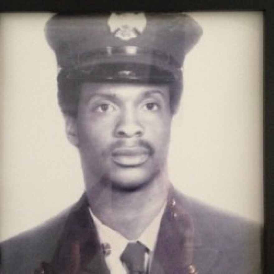 A black and white portrait photo of a firefighter