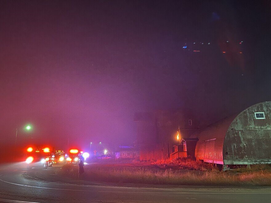 A hole in the wall shows orange flames burning inside the Old Swanson’s Apartment building on Oct. 5, 2020 just after 7 a.m.