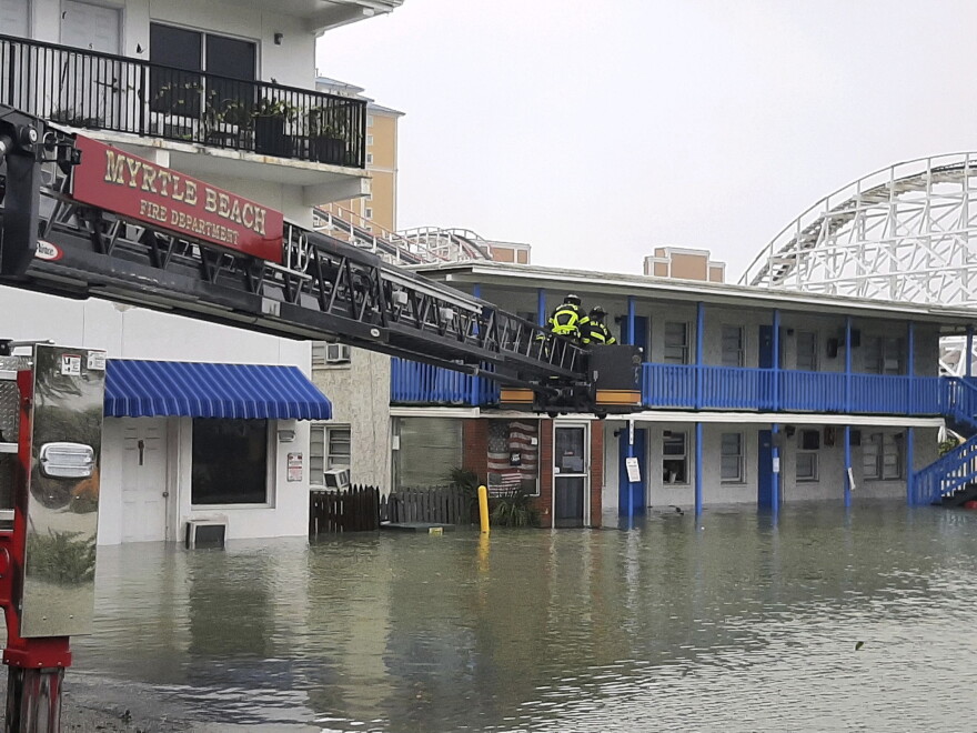 This photo provided by the Myrtle Beach Fire Dept., crews respond to rescue people who were trapped on the second floor due to flooding caused by Hurricane Ian, on Friday, Sept. 30, 2022 in Myrtle Beach, S.C.