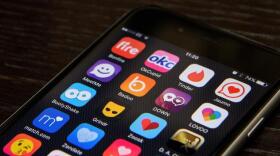 A selection of online dating app logos are seen on a mobile phone screen. Google searches for "dating" have jumped to a 5-year high.