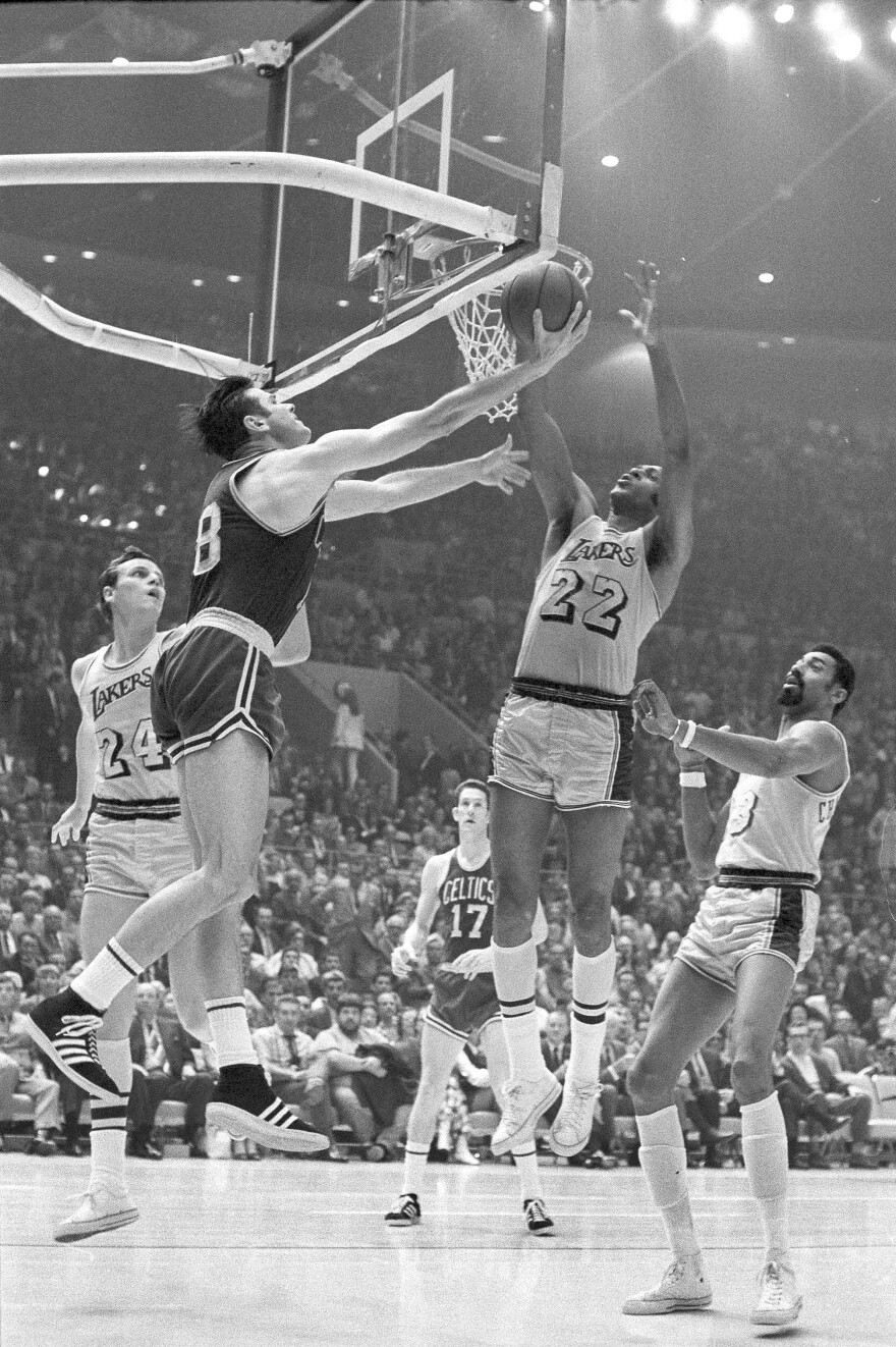 Elgin Baylor (right) of the LA Lakers blocks a reverse lay up attempt by Boston Celtics' Bailey Howell in Los Angeles on May 5, 1969.