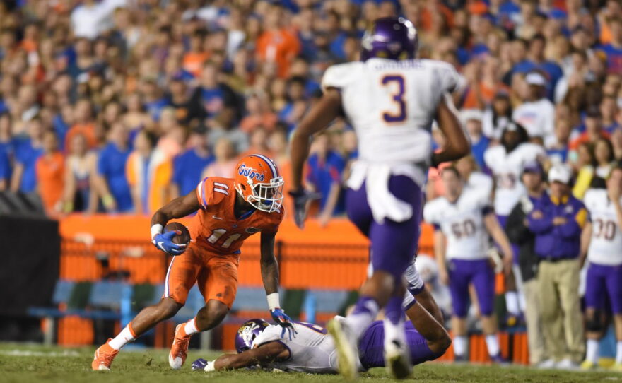 Florida wide receiver Demarcus Robinson (11) pushes East Carolina defensive back Bobby Fulp (8) into the ground after catching a pass and juking other defenders.