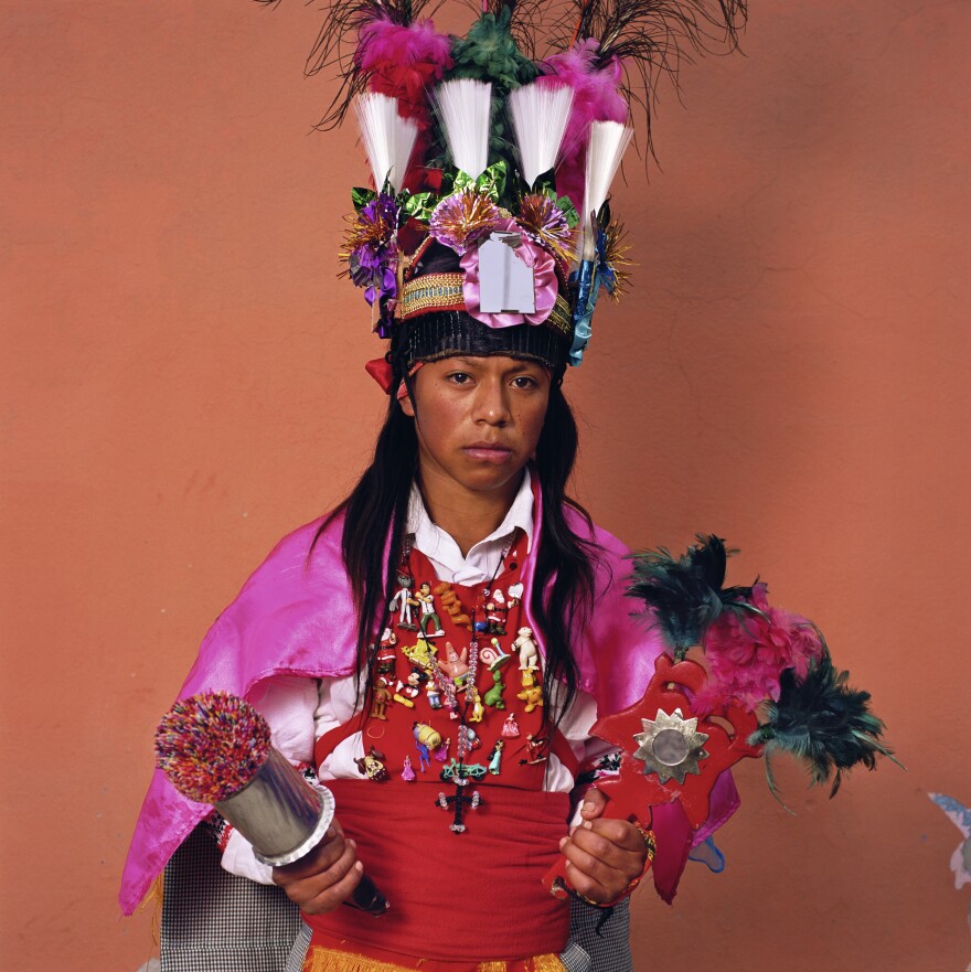 This celebrant is dressed in Spanish-style garb as one of the "Tocotines" — the soldiers of St. James who help him battle evil. They also keep marauding birds away from corn.