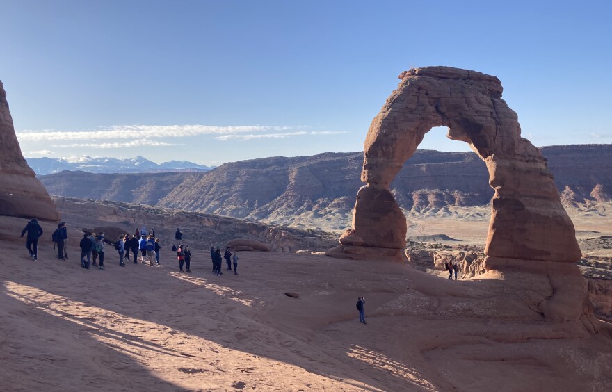 Visitors line up to take a photo at Delicate Arch in Arches National Park on March 21, 2021. The park closed at least 10 times due to overcrowding in March.