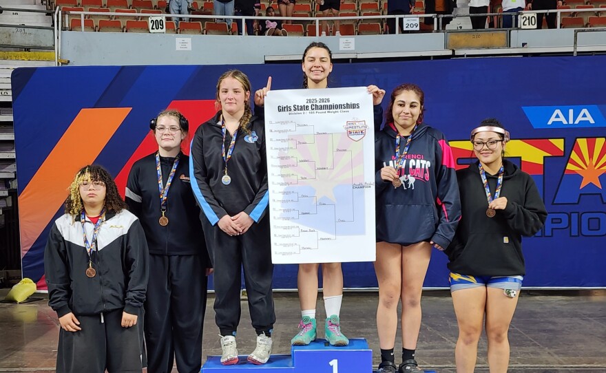 Somerton's Annette Preston stands atop the medal podium for finishing in first place in the 185-pound weight class in girls Division 2.