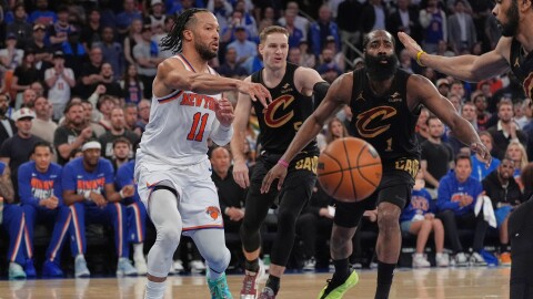 New York Knicks' Jalen Brunson, left, passes under the basket during the second half of Game 1 in the Eastern Conference finals NBA basketball playoffs series against the Cleveland Cavaliers, Tuesday, May 19, 2026, in New York. 