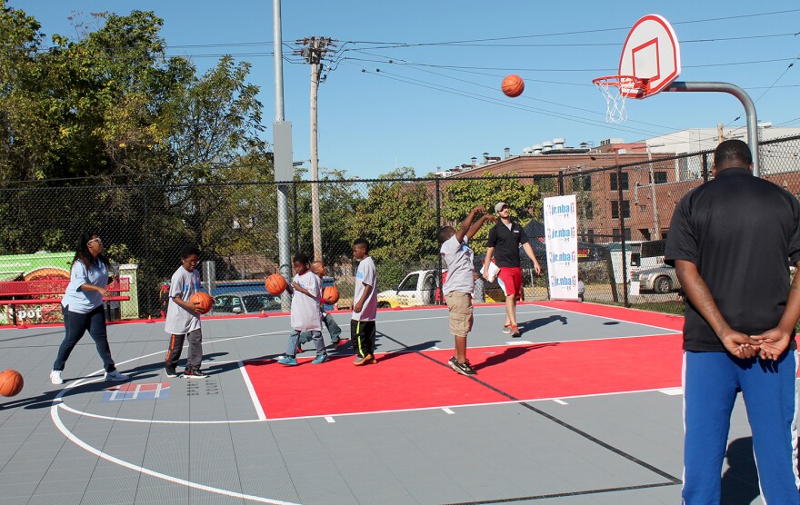 The Jr. NBA, which donated funds for the basketball court at Trojan Park, holds a clinic during the opening ceremonies on Oct. 8, 2016.