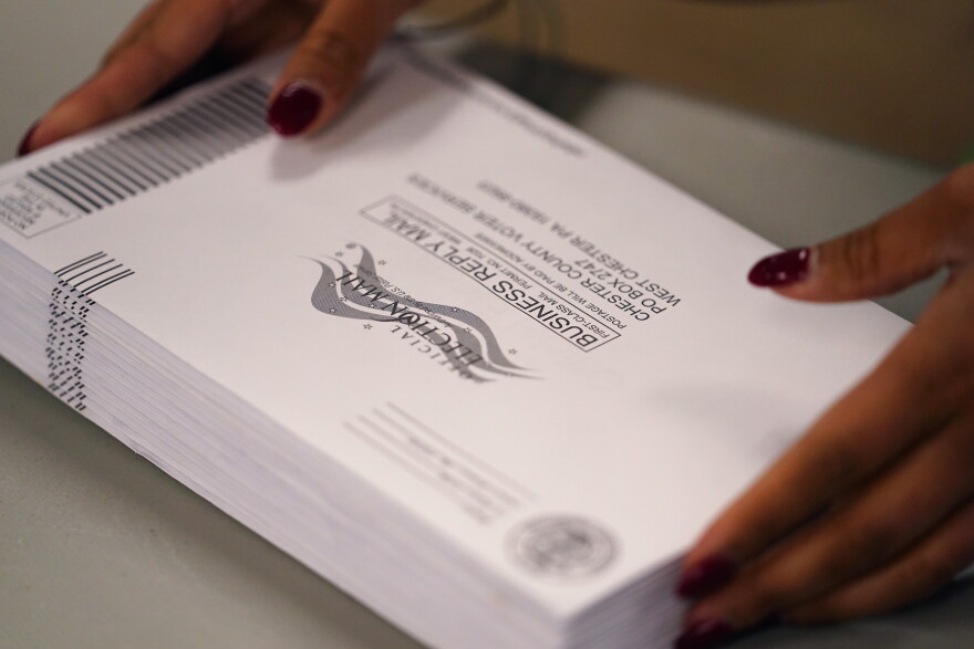 A Chester County election worker processes ballots for the Pennsylvania primary election at the Chester County Voter Services office, Thursday, May 19, 2022, in West Chester, Pa. 