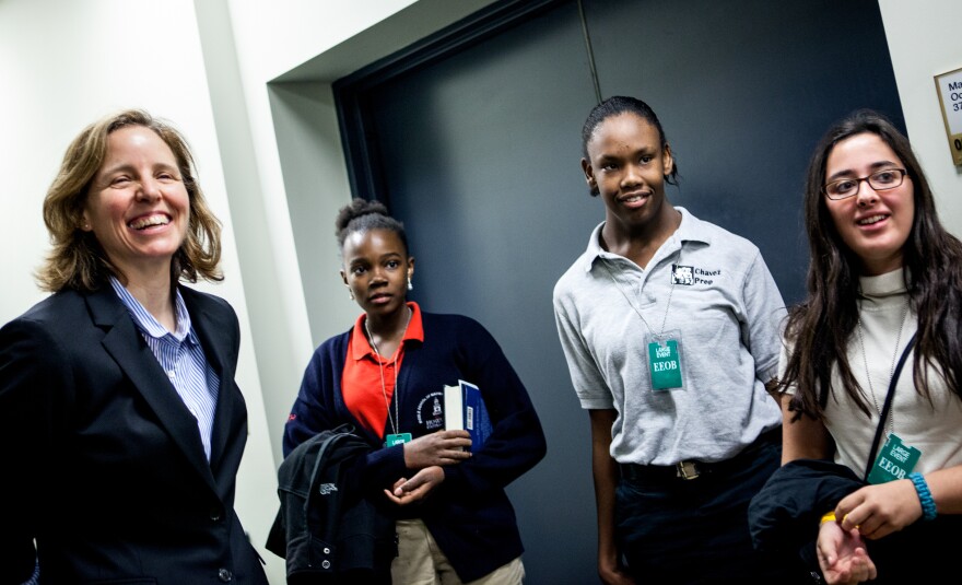 Megan Smith, left, meets with middle school students Mikaelle, from Howard University Middle School; Shayna, from Chavez Prep; and Hannah, from School Without Walls after her presentation.
