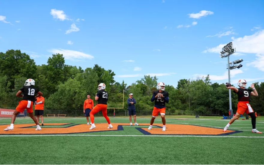 Quarterbacks Amari Odom (12, Blue), Danny Lauter (21, Blue), Joe Filardi (13, Blue), and Steve Angeli (9, Blue) practicing at Fall Camp.
