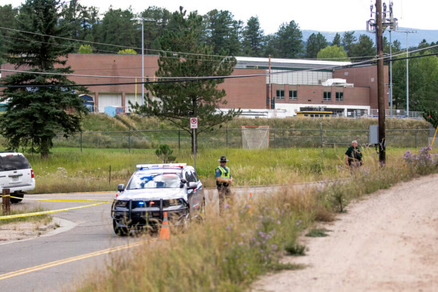 Police officers guard the way to Evergreen High School after a shooting there on Sept. 10, 2025.