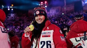 U.S. freestyle skier Kayla Kuhn poses with her gold medal at the closing ceremony of the 2026 Winter Olympics, in Verona, Italy, Sunday, Feb. 22, 2026.