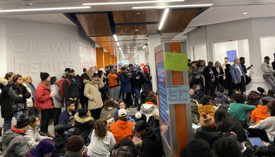 More than 100 Syracuse University students staged a sit-in on campus Wednesday, protesting the university's response to racist messages found in a residence hall