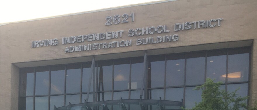 Front of glass and brick building. The building has "Irving Independent School District Administration Building" written on it.